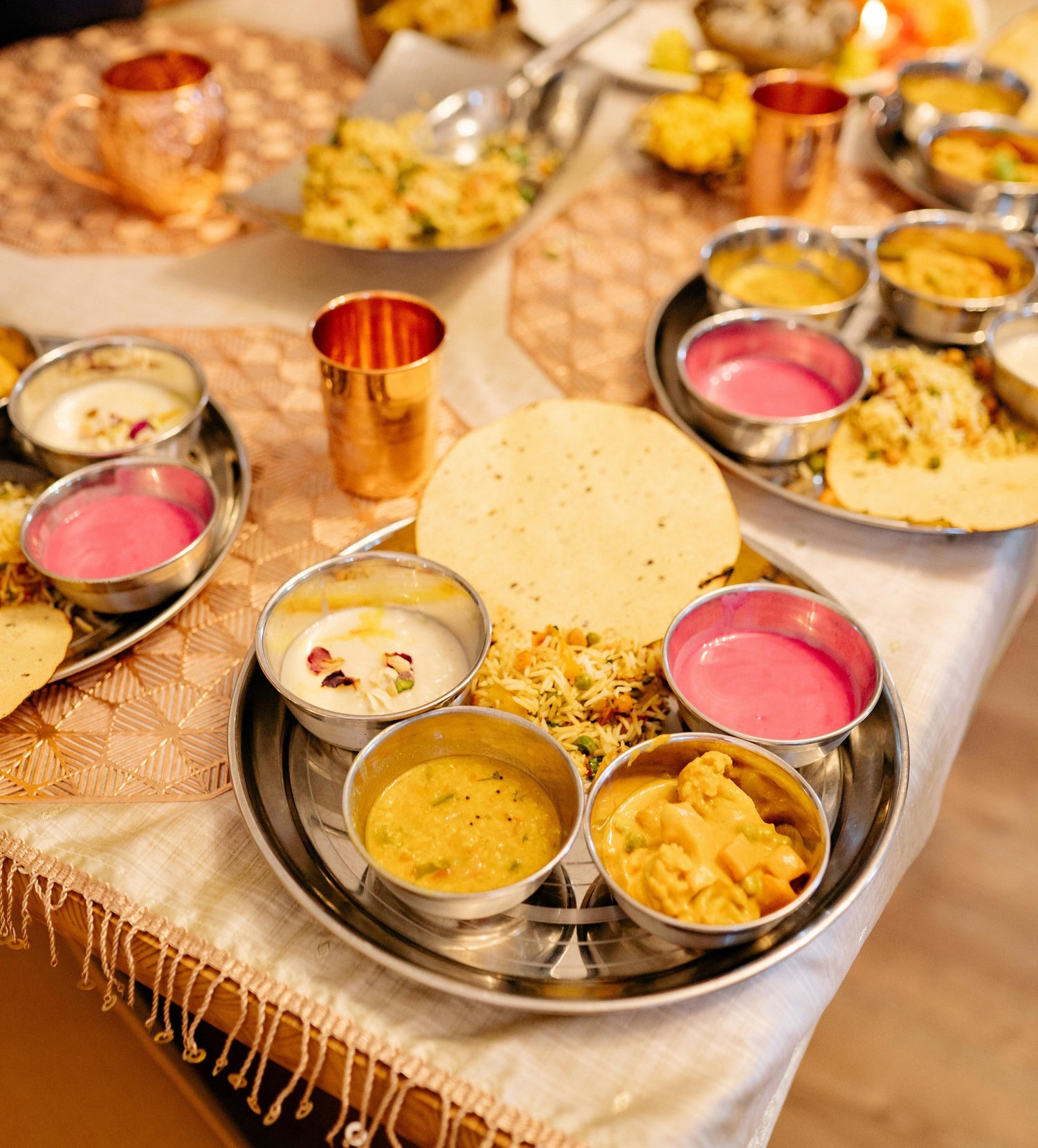 An elegant dinnerware set arranged neatly on a table, featuring plates, bowls, cups, and saucers with intricate patterns and vibrant colors.