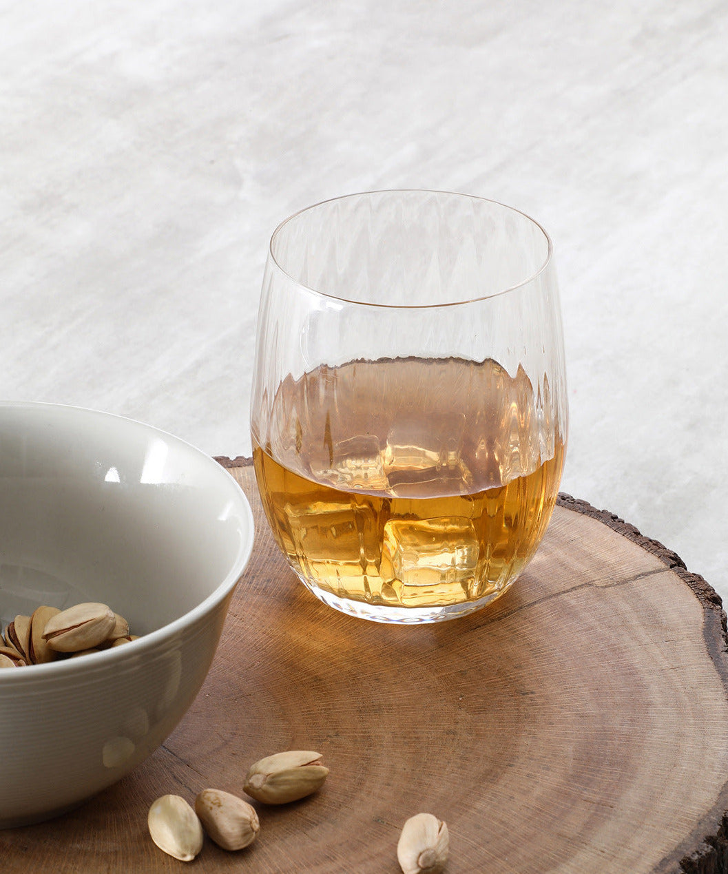Waterfall Crystal Whiskey Glass being held up to the light, showcasing its clarity