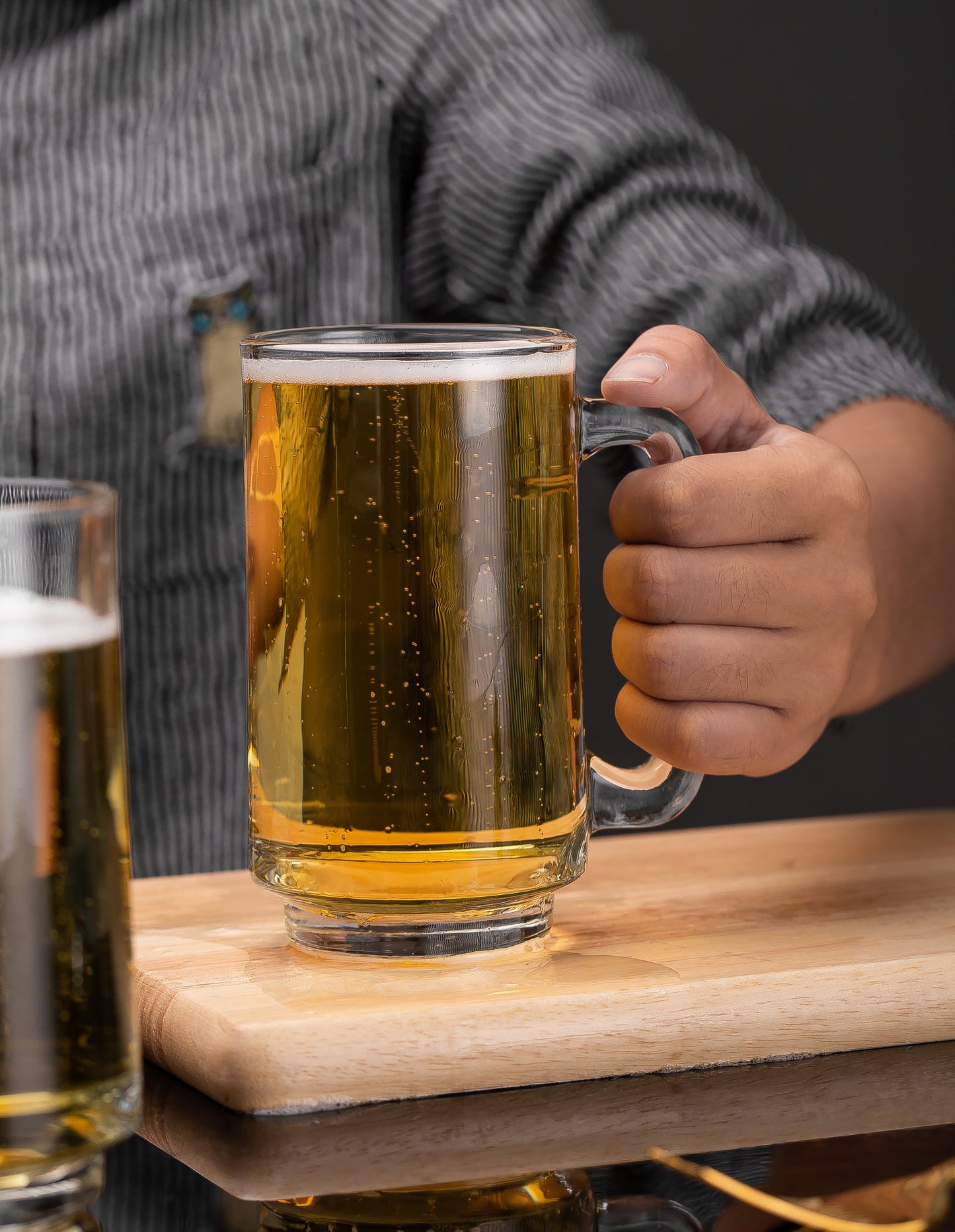 Hand lifting a Frosty Brew Beer Mug with confidence.