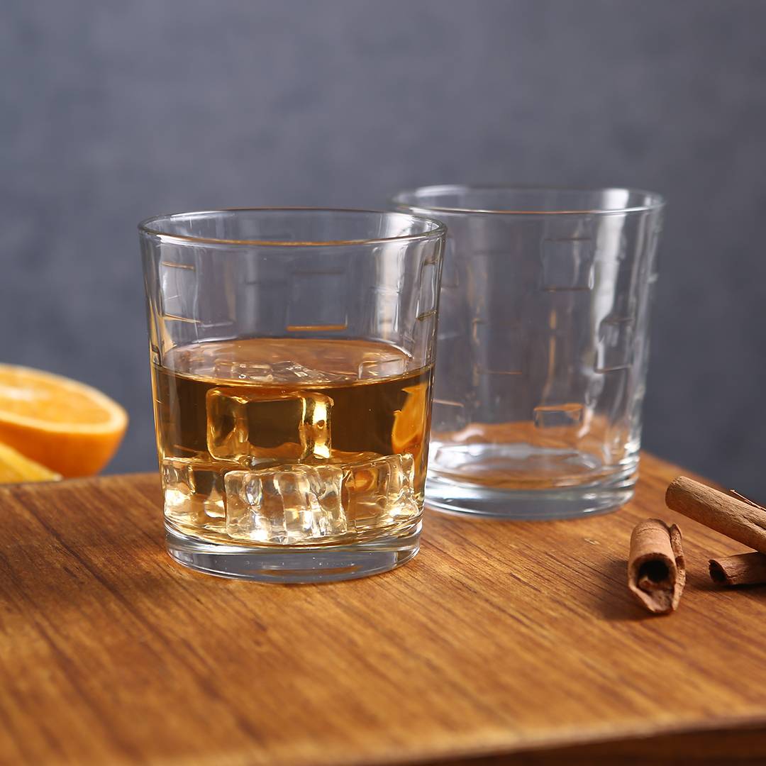 Side profile of the Kyvos Whiskey Glass filled with amber whiskey.