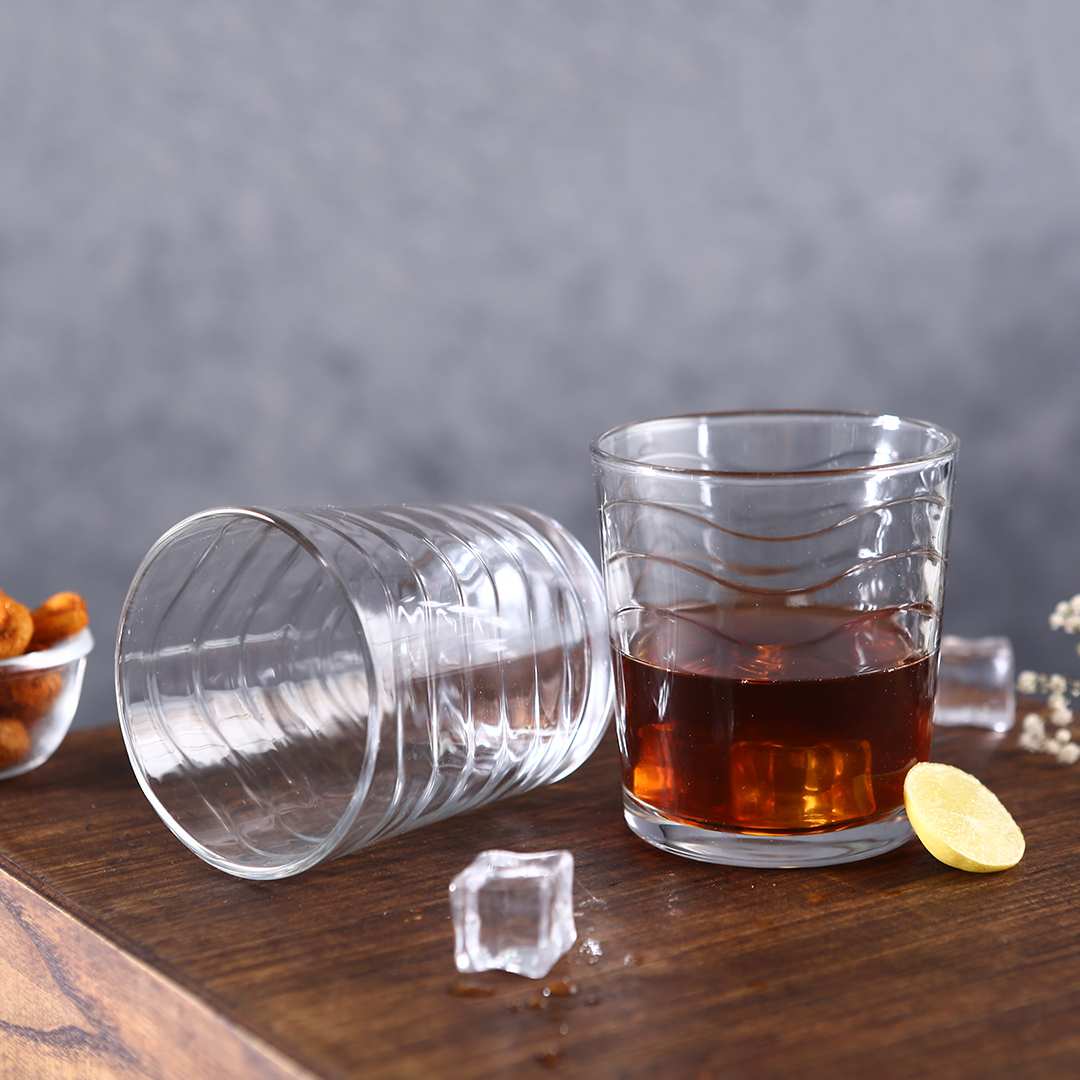 Kyma Whiskey Glass Set elegantly displayed on a modern home bar.