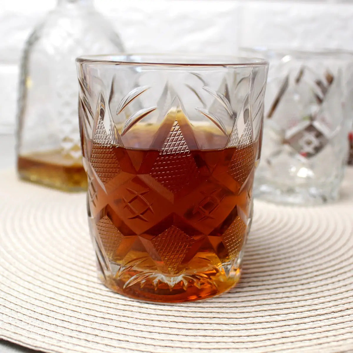 Side profile of the Status Whiskey Glass filled with fine bourbon.
