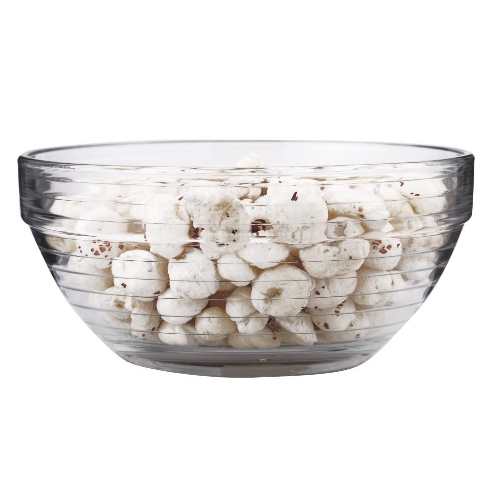 Stackable glass bowls used for serving cooked vegetables.
