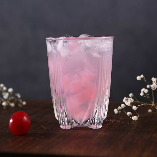 Mont Blanc glass filled with fresh juice on a breakfast table.