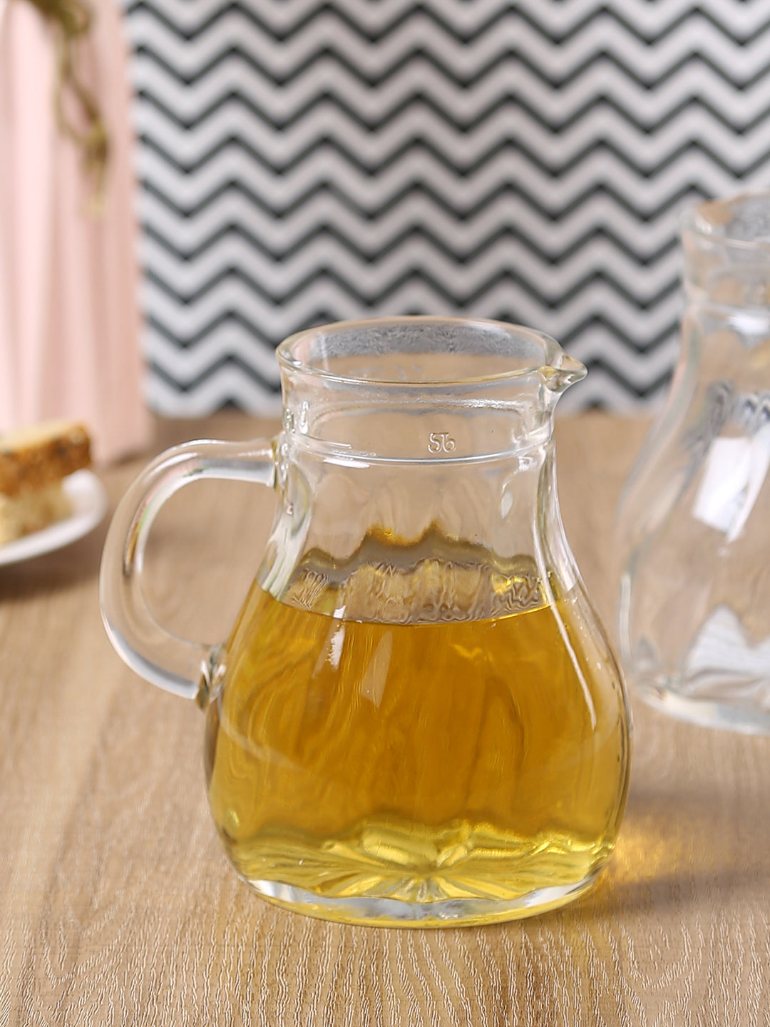 Clear glass jug with easy-pour spout and sturdy handle.