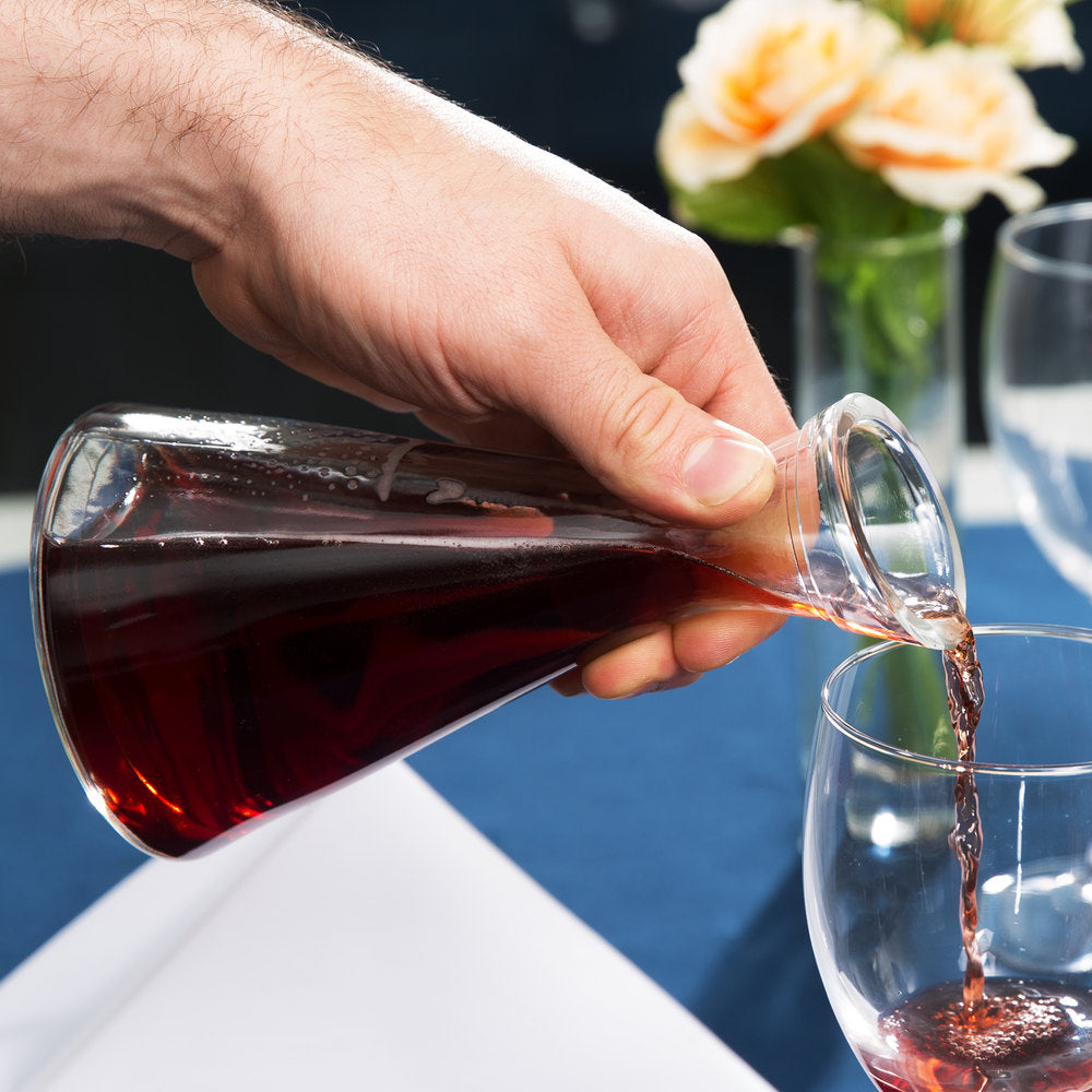 Pisa Decanter pouring red wine into a glass at dinner.