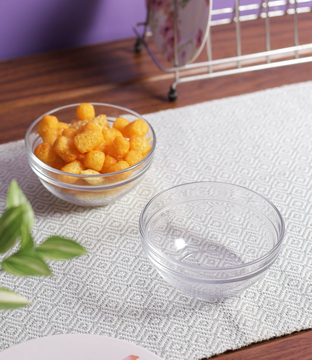Clear glass bowls stacked next to a serving platter.