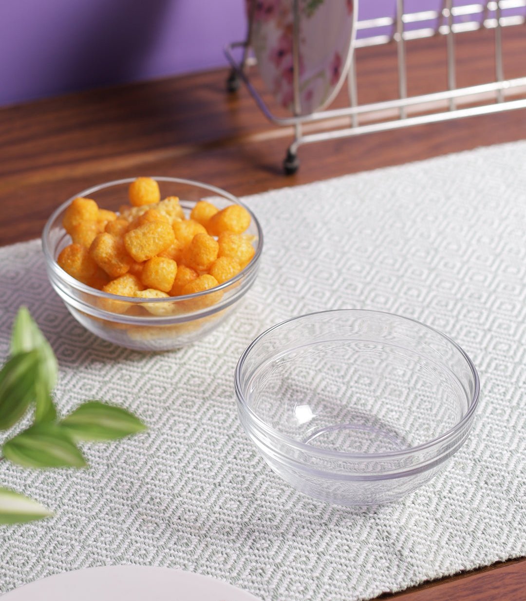 Clear glass bowl filled with fresh salad for serving.