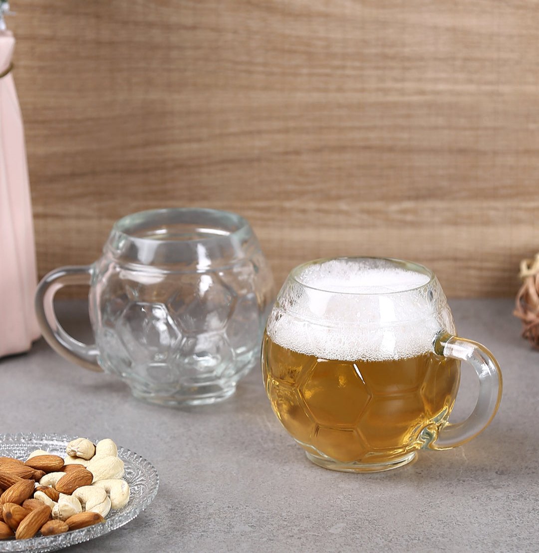 Football Glass Beer Mug filled with beer on a table.