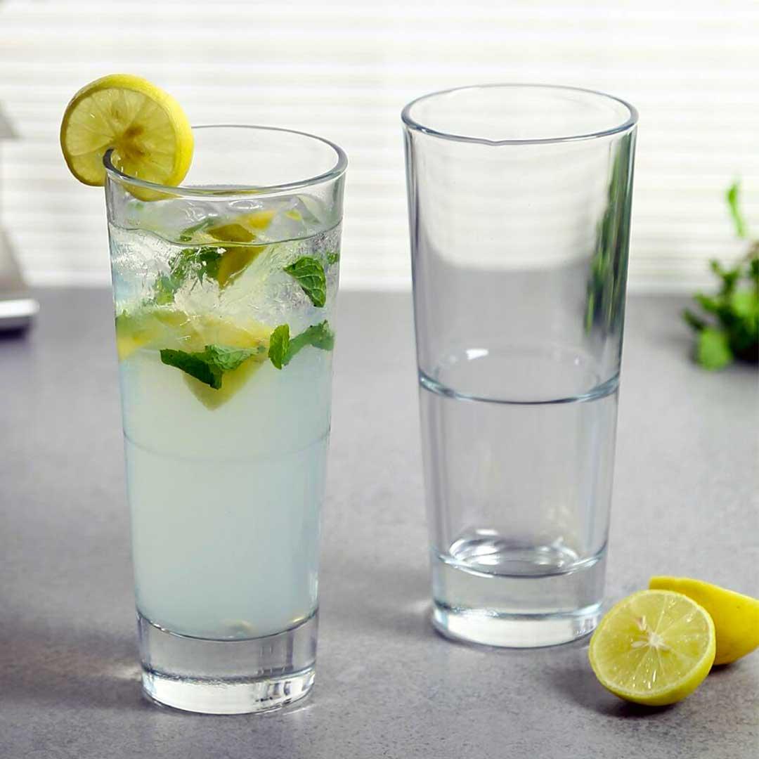 Highball glassware arrangement with cocktail garnishes"