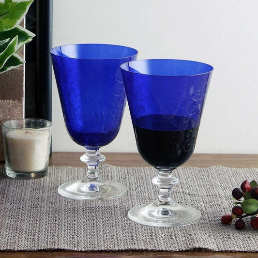 Set of Bella Dark Blue Engraved Glasses on a dining table.