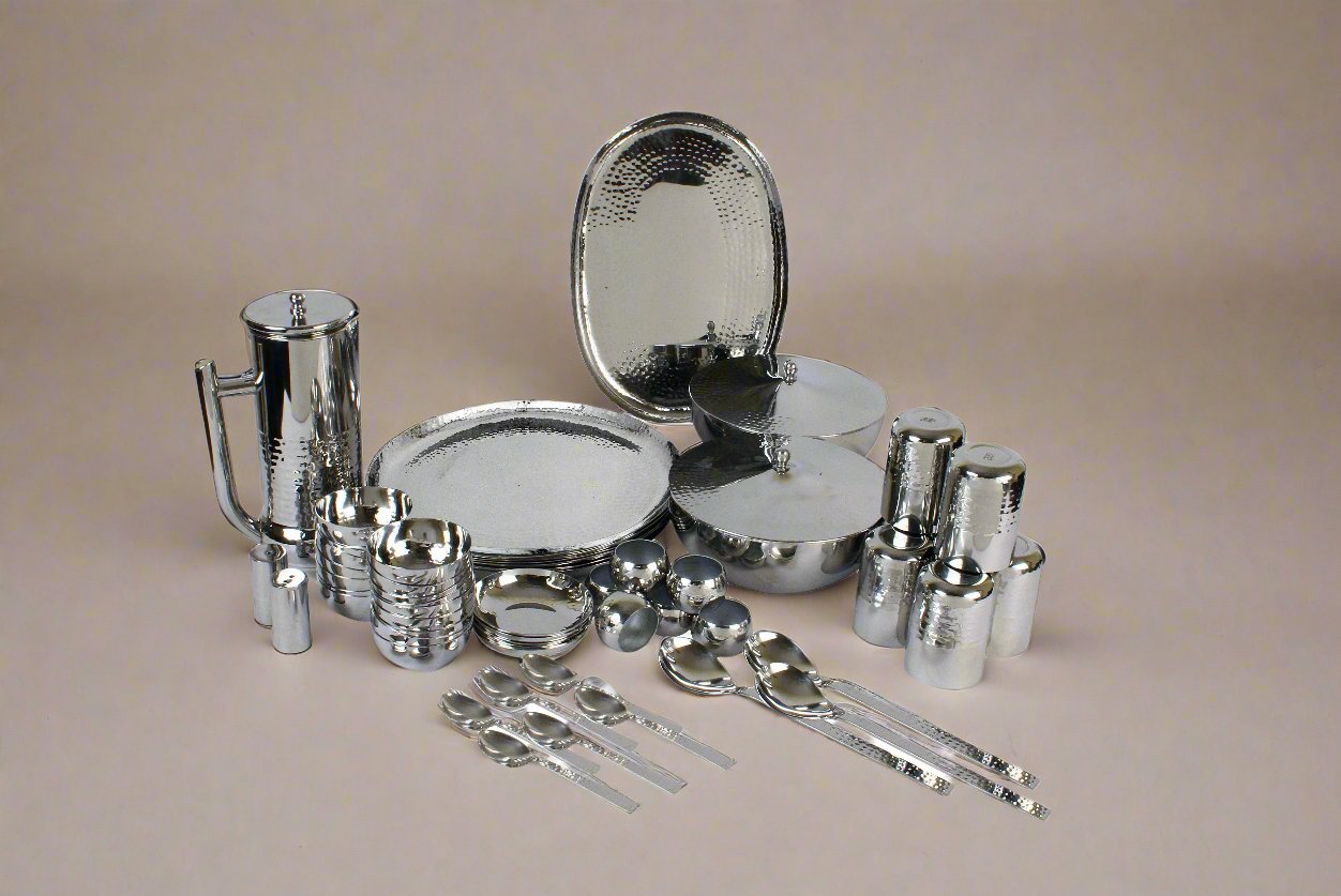 Complete Groove 57 pcs stainless steel dinner set displayed on a dining table.