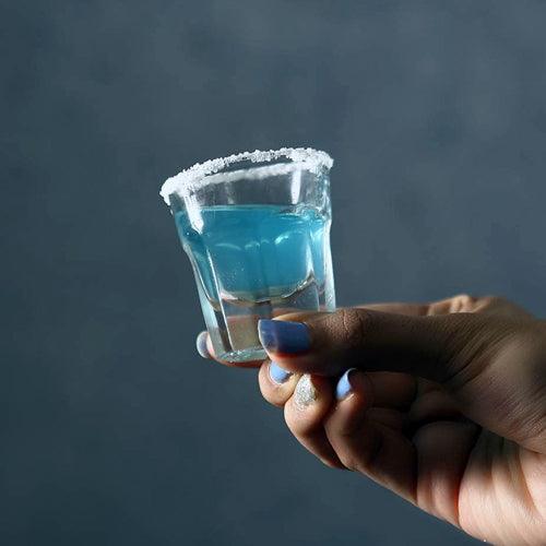 Hands holding Marocco Shot Glasses with colorful drinks