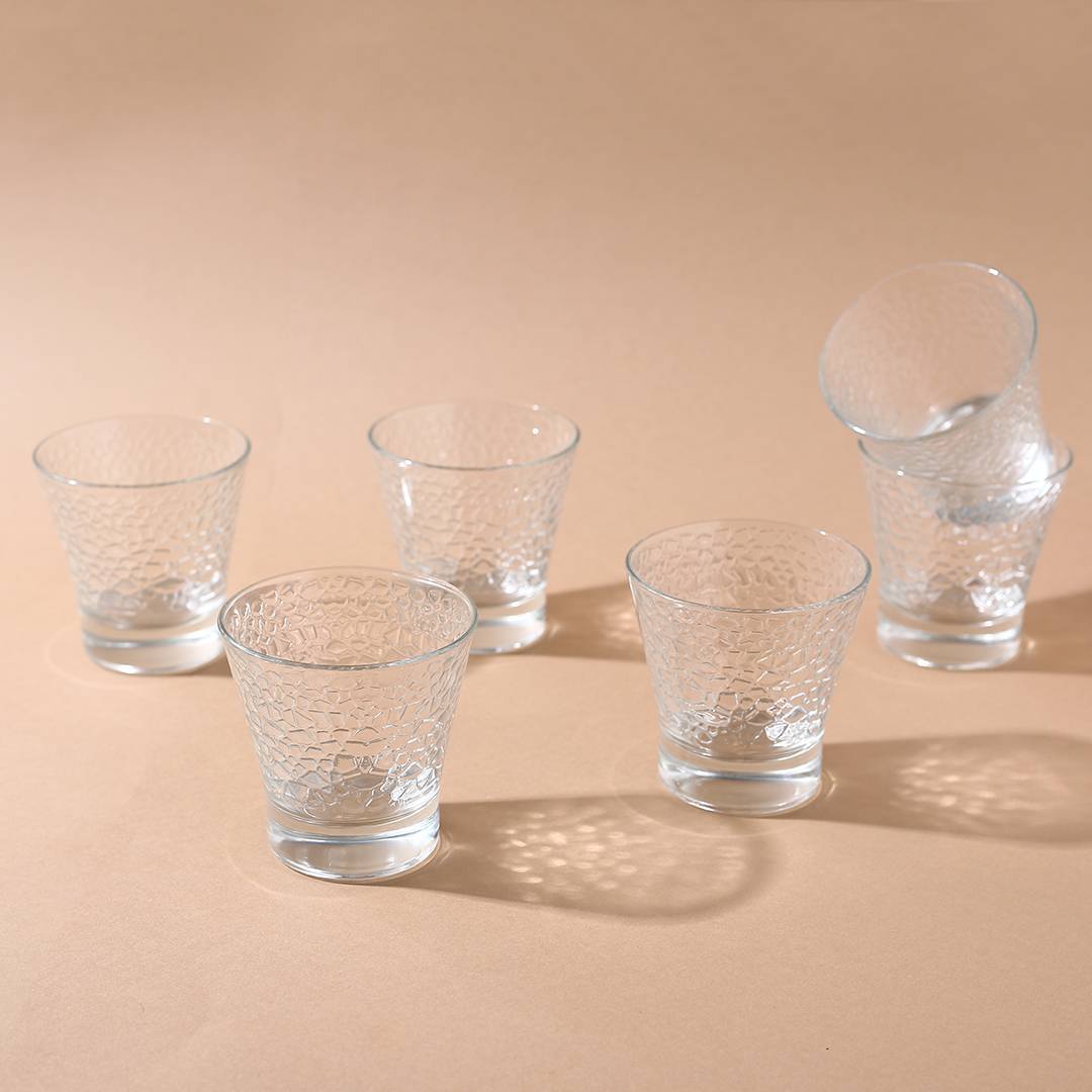 Light reflecting through the exquisite pattern of the Rome Whiskey Glass.