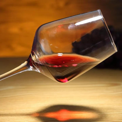 Clear crystal wine glass with a long stem and wide bowl.