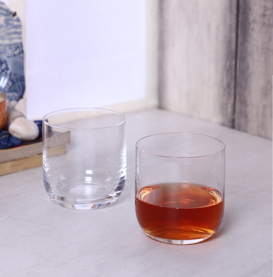 Uma Whiskey Glass with a splash of whiskey and a whiskey stone