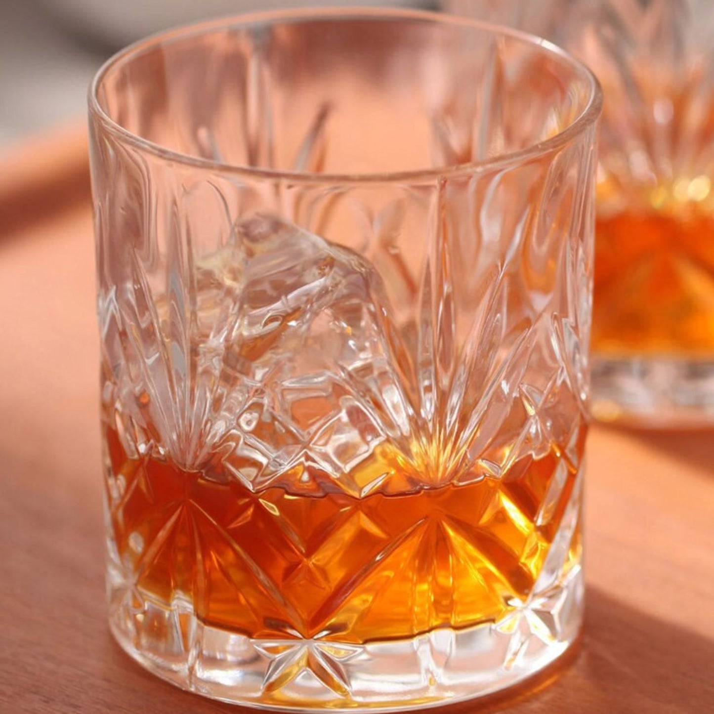 Whiskey Glass on a wooden tabletop.