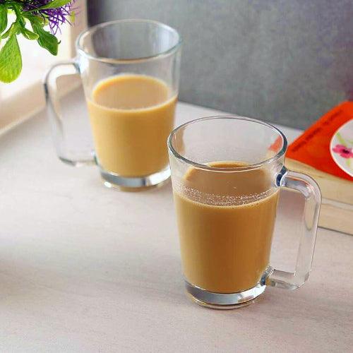 Angeles Glass Mug filled with steaming tea on a cozy table.