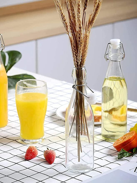 Flip top glass water bottle on a kitchen counter.